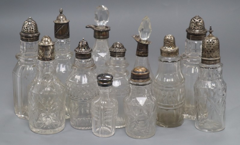 Six assorted 19th century silver topped glass cruets and six others with plated or white metal mounts, largest 18.5cm.